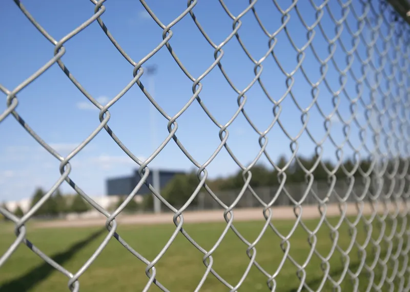 Galvanized chain link fence along a property line