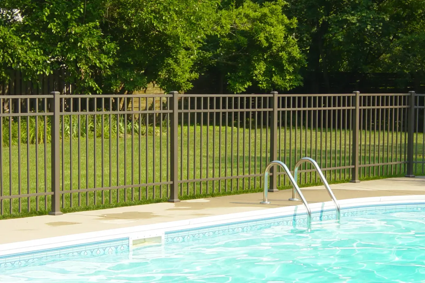 Black aluminum pool fence with a self-closing gate