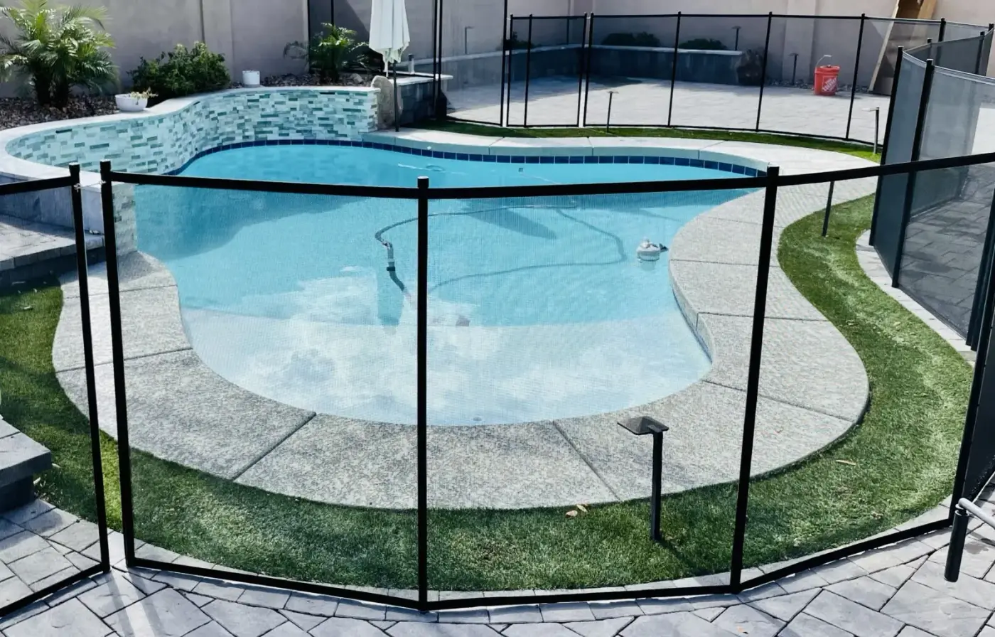 Removable mesh safety fence around a backyard pool